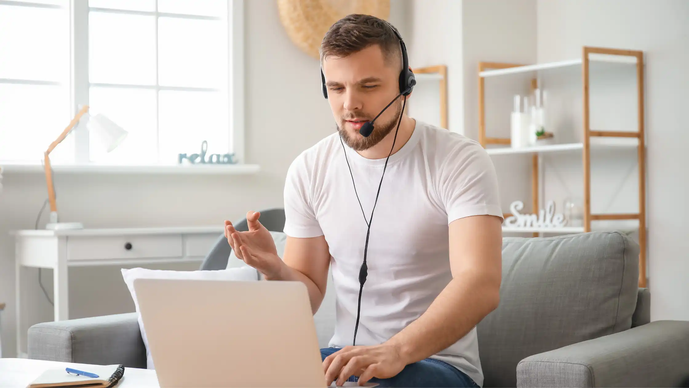 A male call center agent is monitoring connectivity using Genesis Cloud